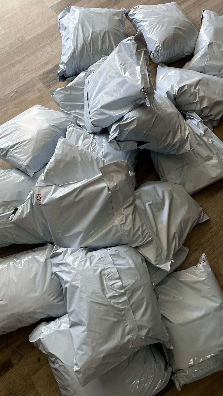 Floor covered in packed grey mailer bags